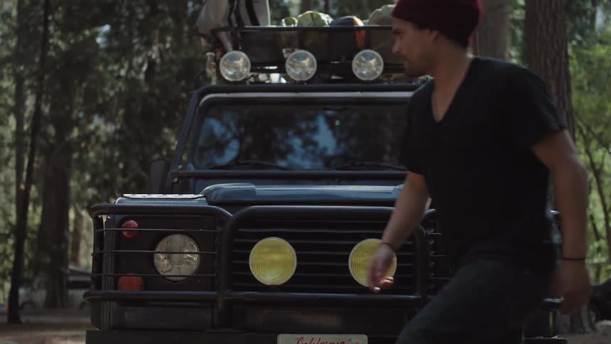 Men exit a vehicle in the woods