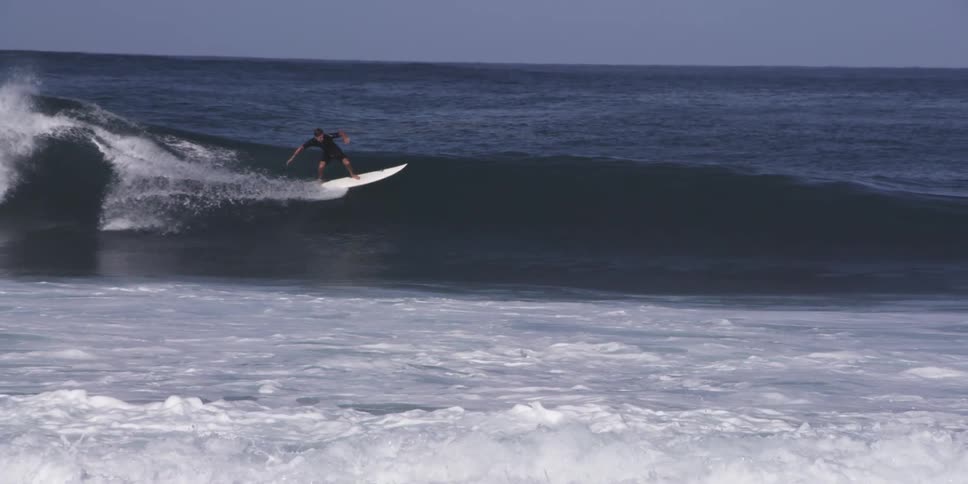 Surfer rides a wave in the ocean