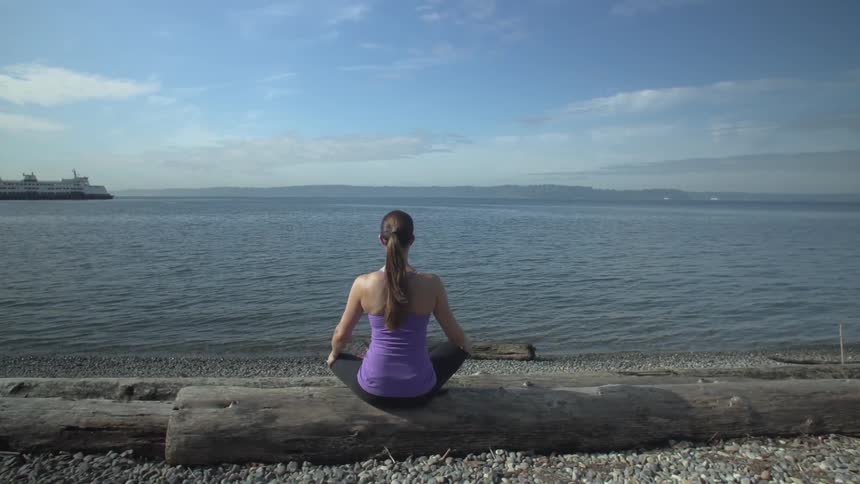 Woman on beach stretching