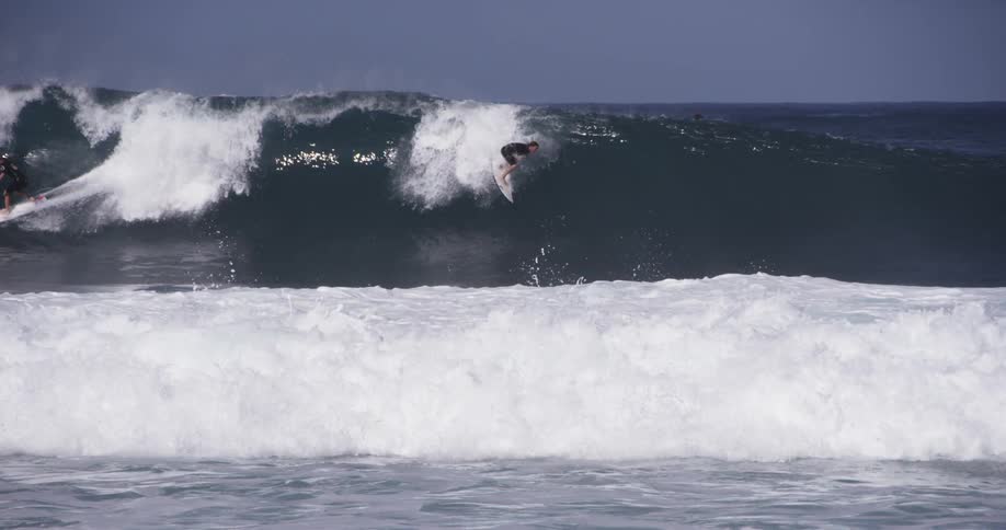 Mean people surfing large ocean waves