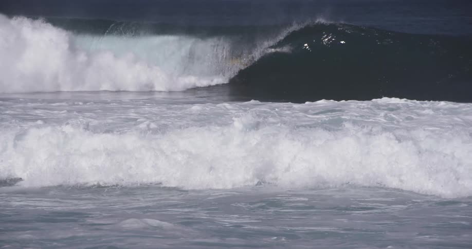 Person surfs ocean waves and gets engulfed by the wave