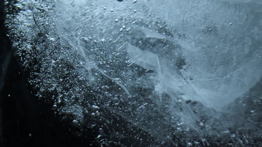 A piece of ice is spinning in the dark