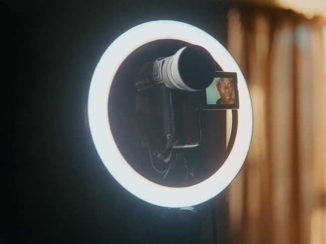 Professional camera positioned on a round light in a studio