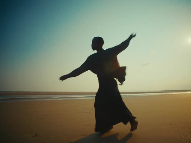 A clip of a person dancing at the beach