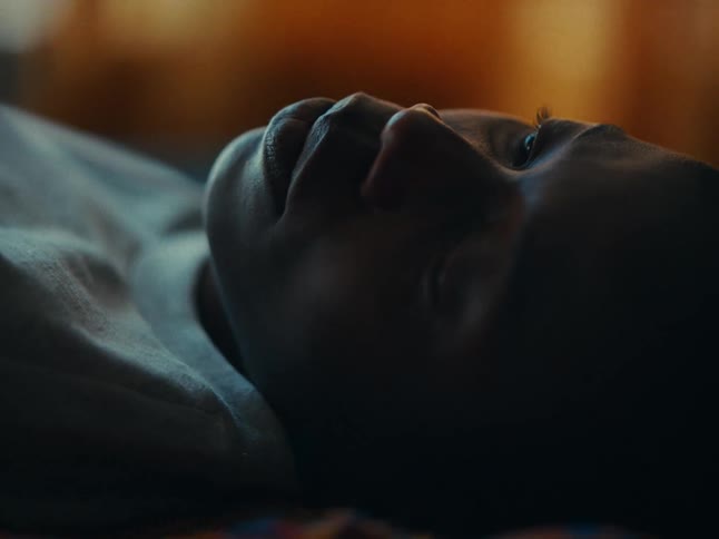A clip of a persons face while laying down