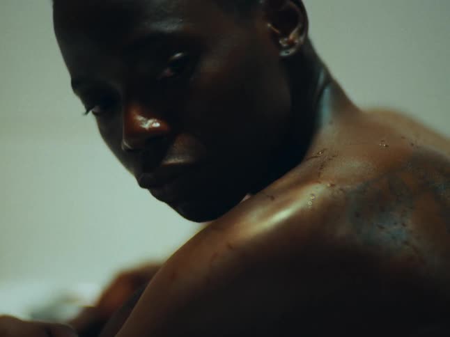A woman in the tub lifts her head