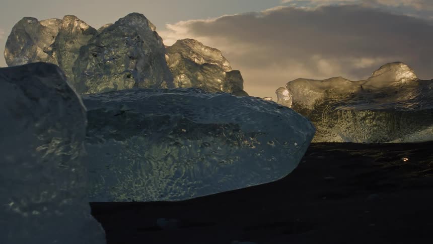 Glaciers on black sand at dawn