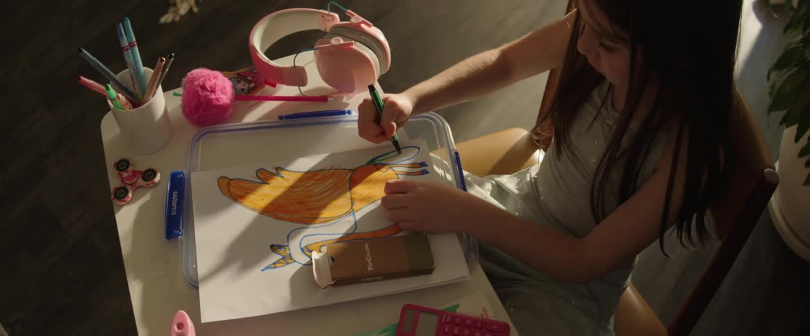 Little girl sitting painting a picture