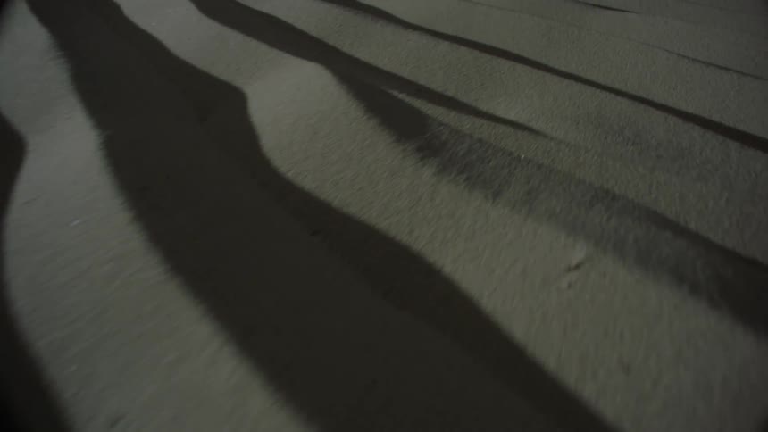 Aerial view of sand reliefs with reflections of light and shadow