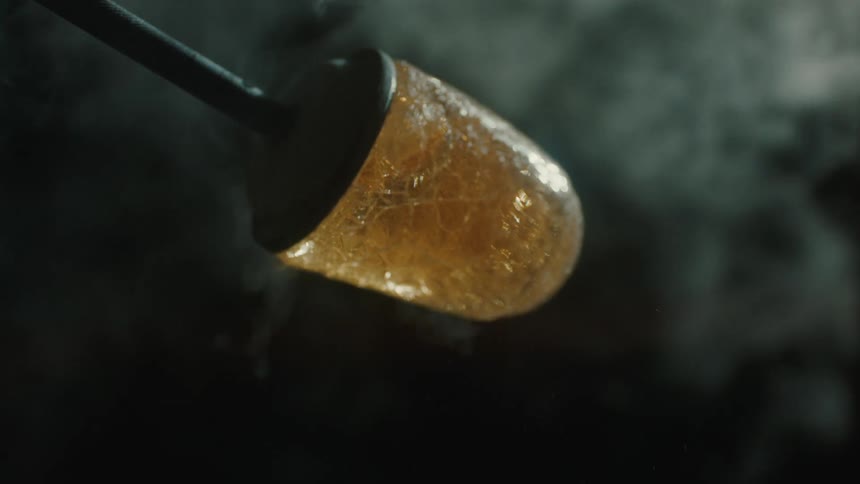 Close up of forged glass with abstract smoke in the background