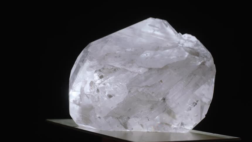 Light shines onto a large translucent white crystal