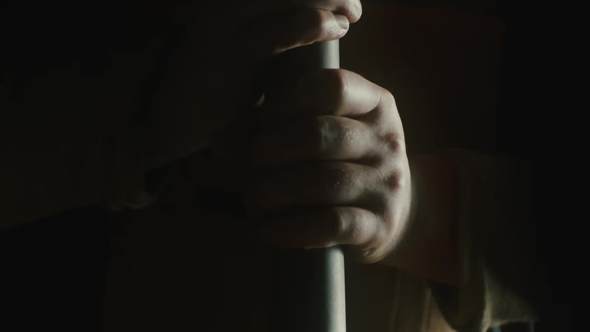 Pair of hands of a man holding a pipe