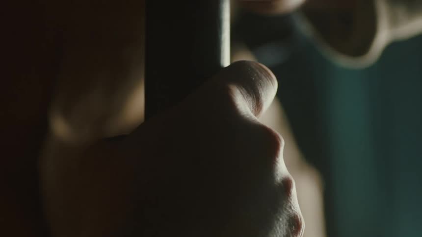 A person is twisting a wooden rod