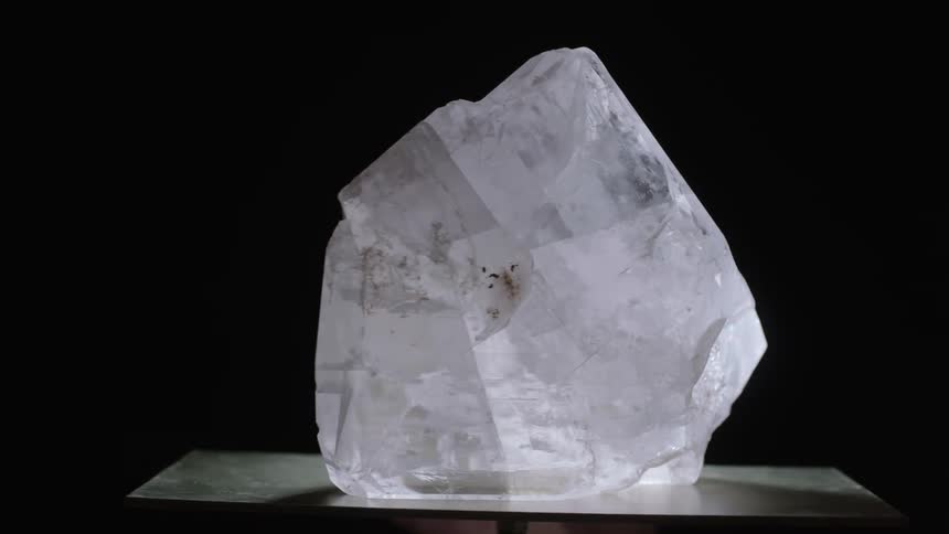 A white crystal is spinning on the platform