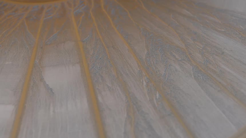 Top view of a white and yellow surface with cracks