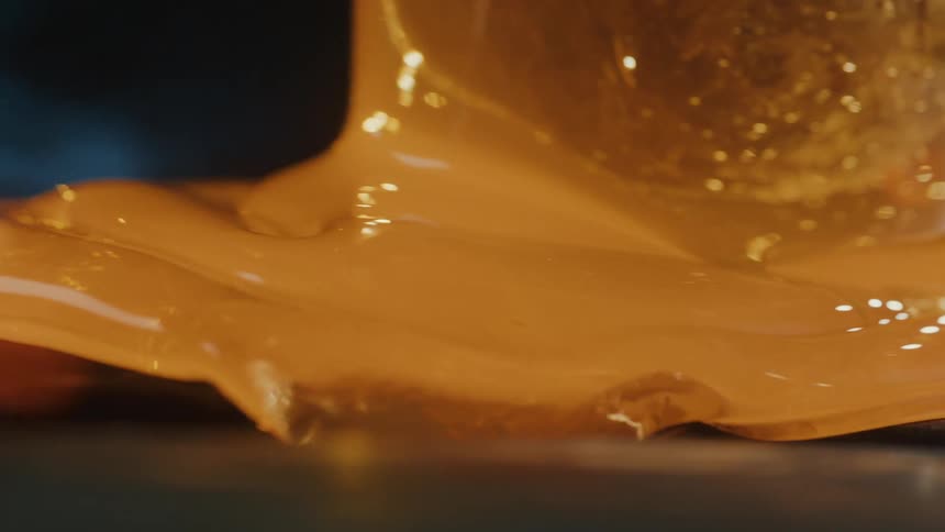 Close up of forged glass spilling onto a surface