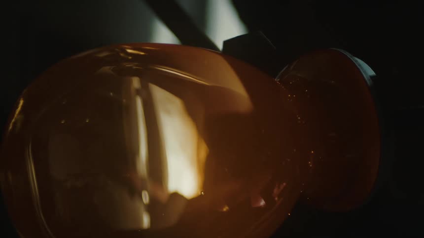 Hot glass is being rolled and formed