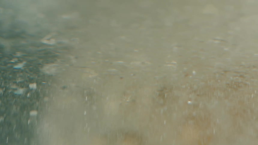 Close up of the textured surface of a glass shape with visible air bubbles