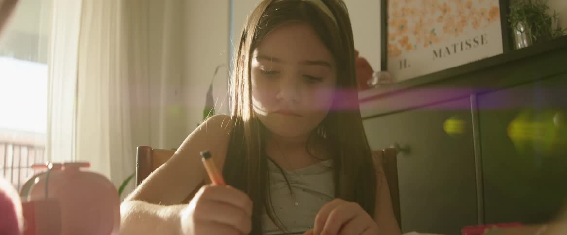 A girl is drawing with a marker