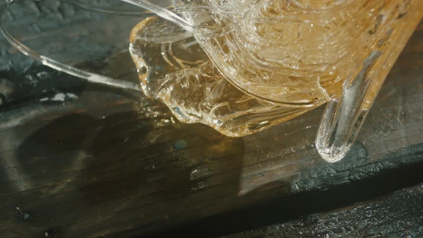 A person is bending the hot glass