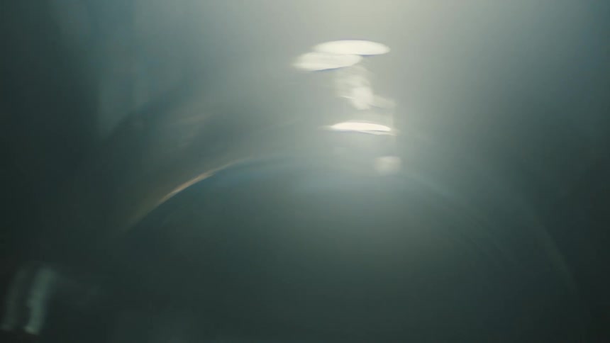 Close up of a glass vase reflecting light in a dimly lit room