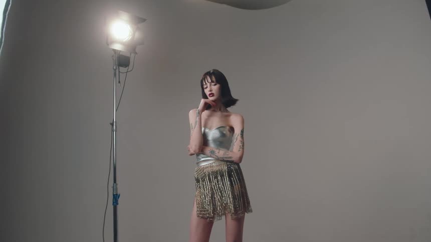 Female model wearing a skirt and bustier posing for a photo shoot