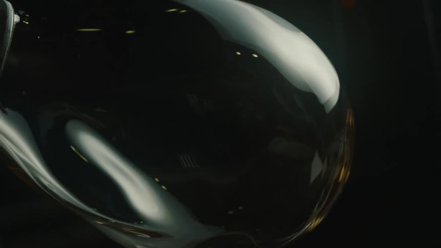 Light reflects off the glass forming on the rod