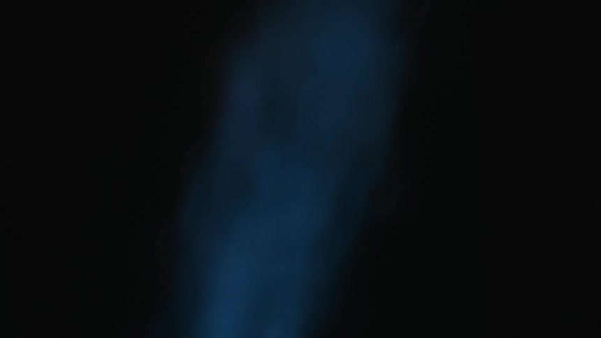 Smoke rises in a line while small flames spark very quickly with the same pace