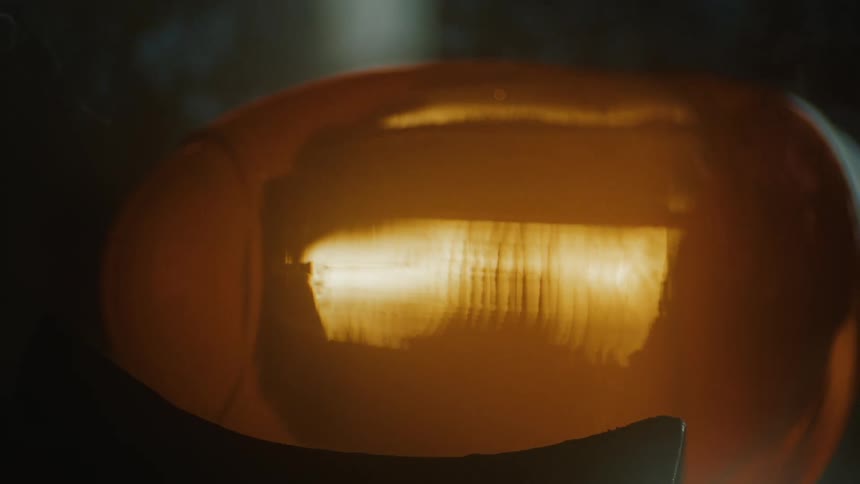 A glowing orange molten glass colored cylinder object with smoke coming out
