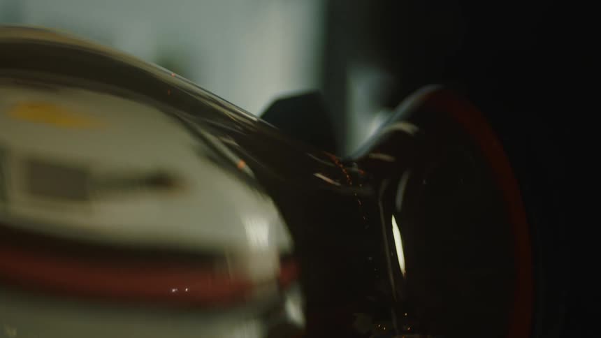 A glass vase is being heated by an open red flame capturing the glassblowing process