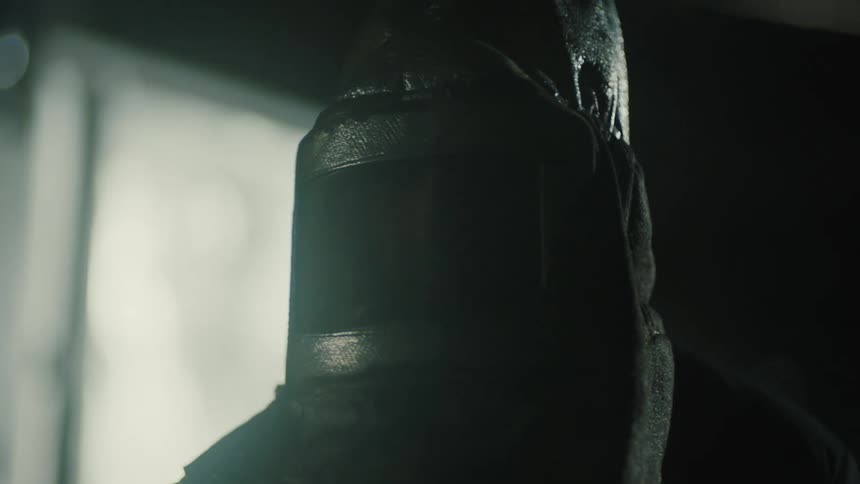 A clip of a person putting on a black mask