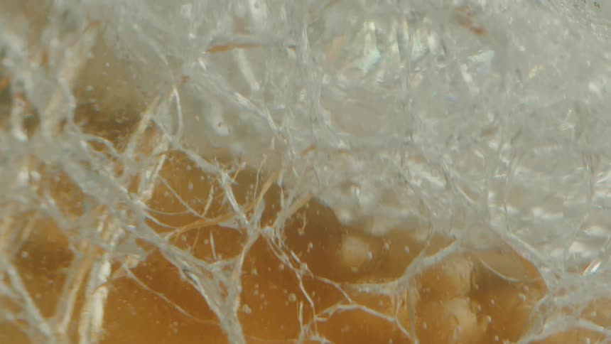 Close up of forged glass in water with bubbles rising around it