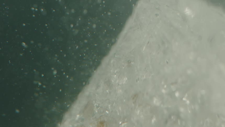 Bubbles rising in a liquid with ice