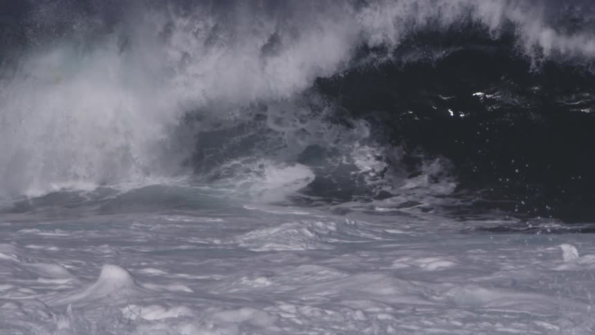 A man jumps off his surfboard