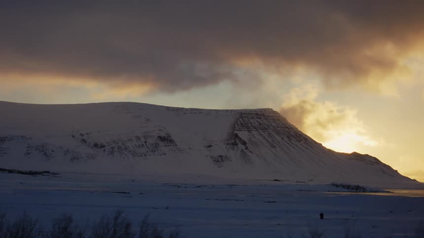 Landscape of a snowcovered mountain on a cloudy day