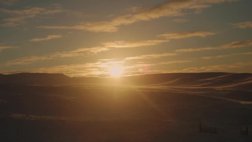 The sun rises on the landscape full of snow