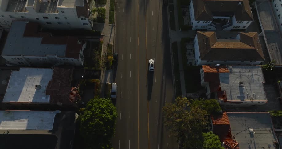 Aerial view of an intersection with vehicle traffic through an urban city