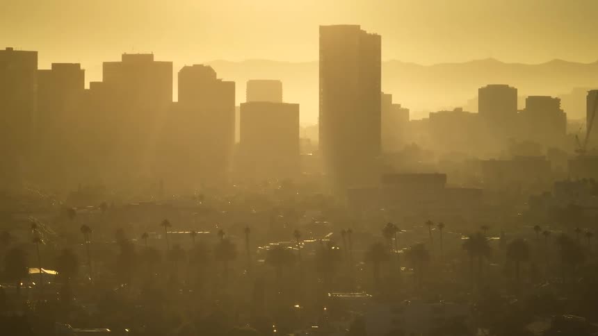The city is covered in heavy smog at sunrise