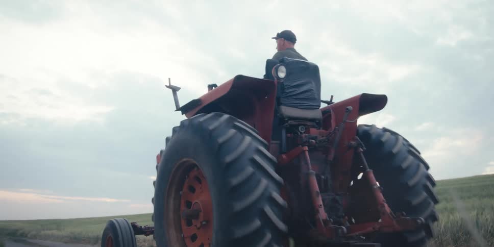 A clip of a tractor moving along the farm