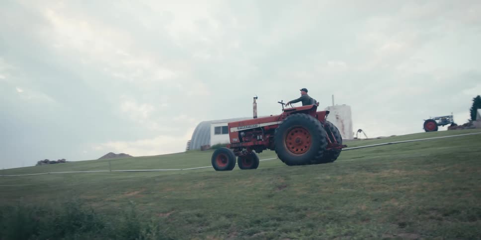 Man driving a tractor in a farm field