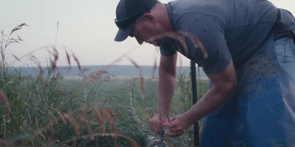 A man turns the irrigation system on to water his farm