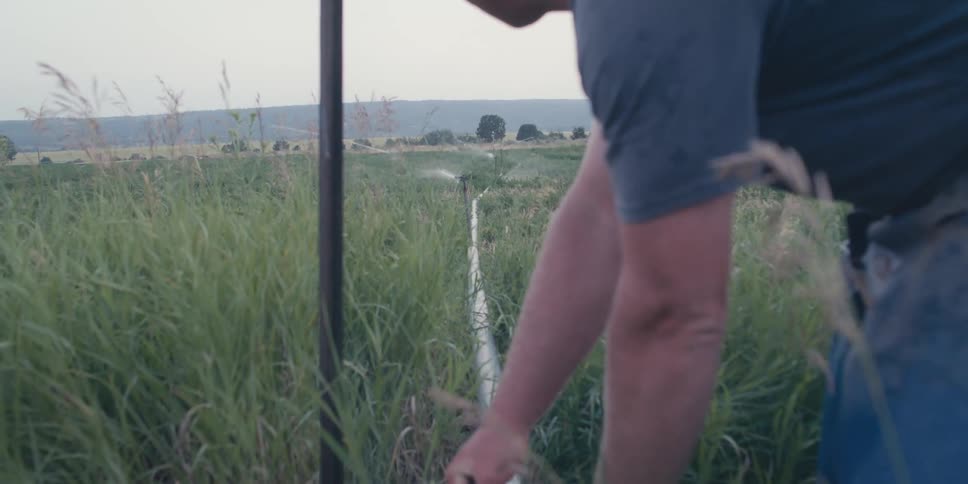 A man works on a water pipe