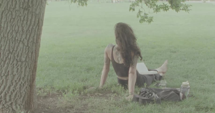A woman is relaxing in the fog filled park