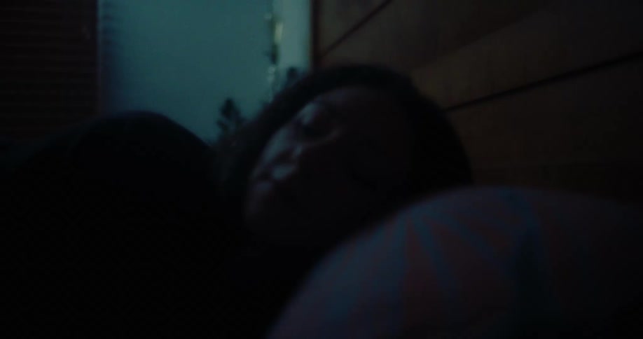 Woman turning off the lamp and lying down to sleep in bed