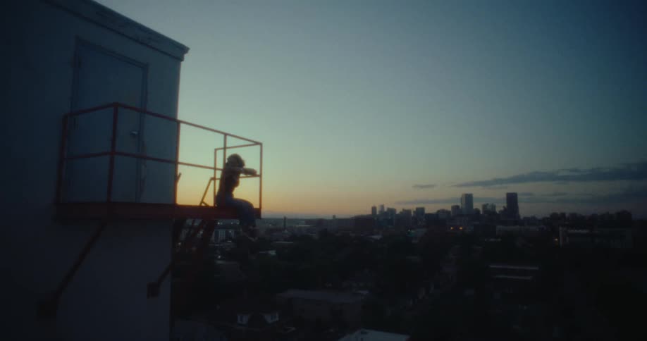 A clip of a person sitting at the balcony