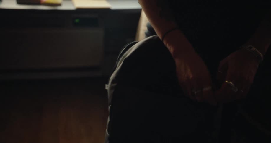 Closeup of a person packing a pencil into a backpack in a room at home