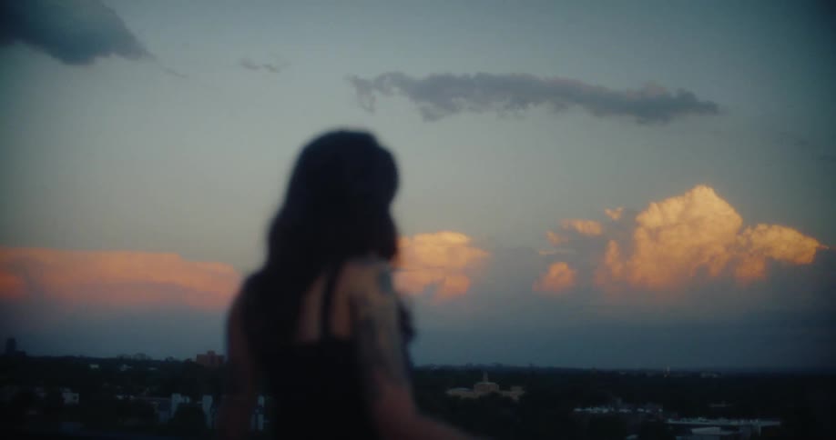 A clip of a lady standing by the balcony