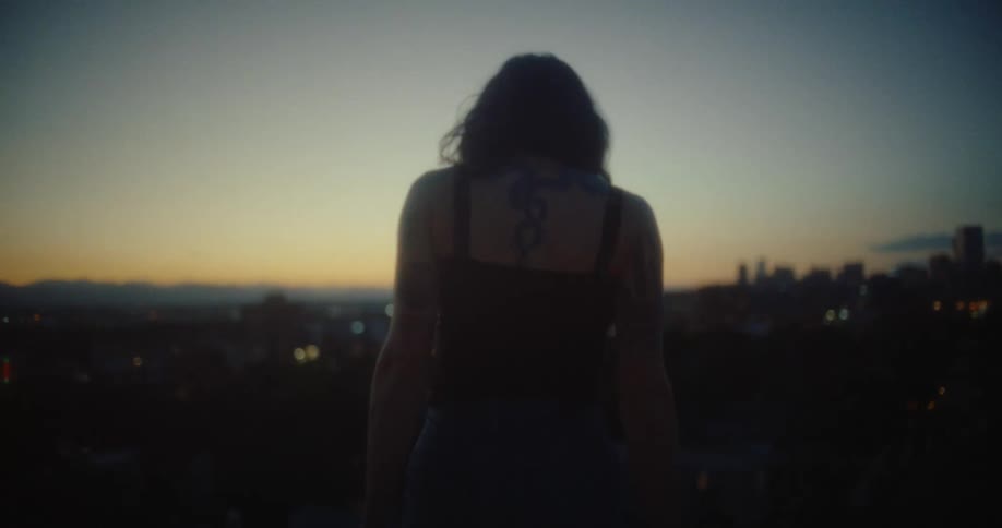 Woman walking down the stairs and having a panoramic view of a city