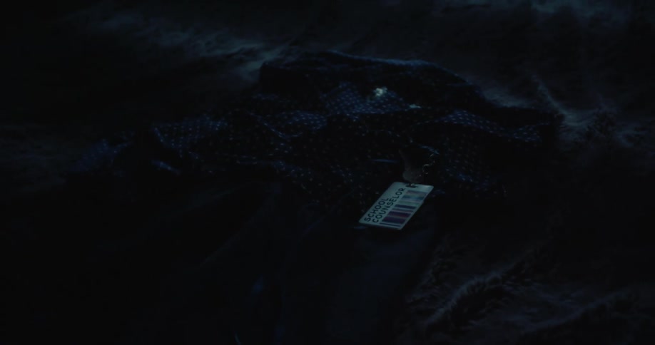 Hand placing a badge on a piece of clothing