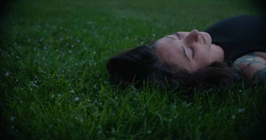 A woman is resting in the grass